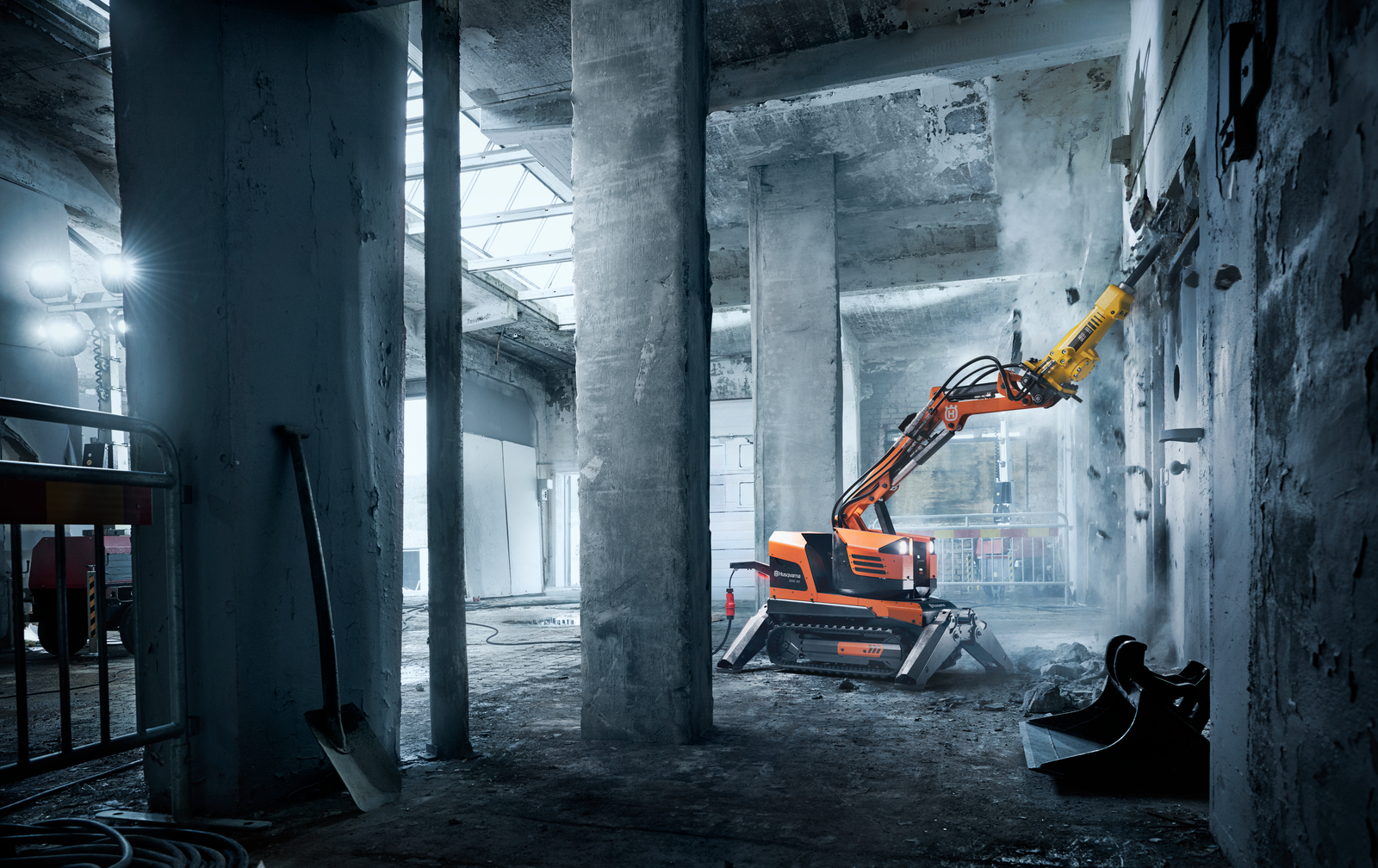 Husqvarna DXR demolition robot breaking concrete in an industrial interior
