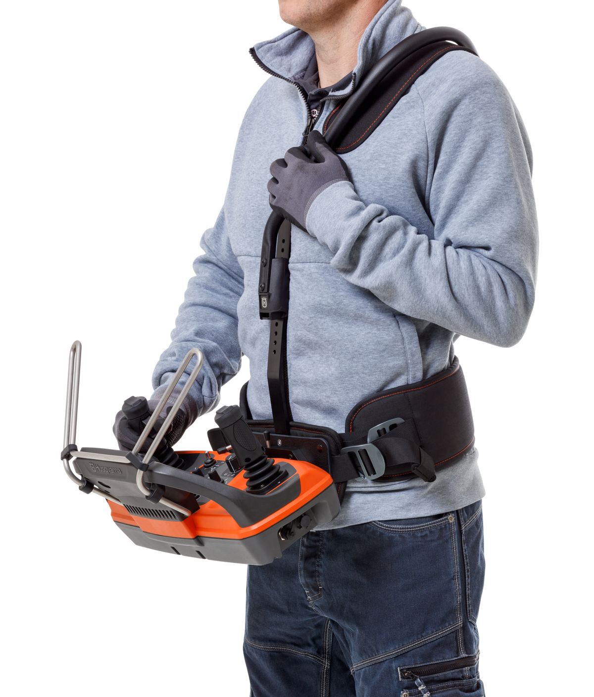 Operator wearing Husqvarna DXR remote control harness with joysticks